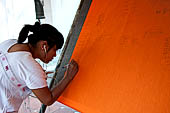 Thailand, Phra Pathom Chedi, the nation's largest pagoda in Nakorn Pathom. People put their names on a banner after their donations to the temple. 